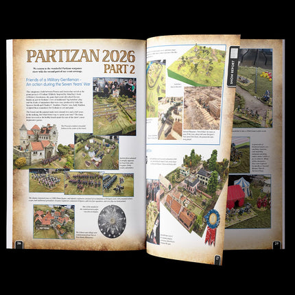 Open boek van Wargames Illustrated Wi464, augustus 2026 met pagina's 24-29, over strategische en miniatuur oorlogsspellen.